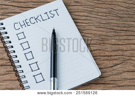 Notepad With Pen And Handwriting Headline As Checklist With Check Box On Wood Table, To Do List, Tas