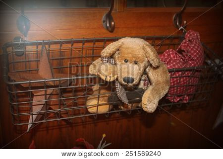 A Vintage Basket With A Teddy Bear And Crafts