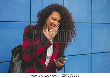 Young People And Youth Problems. Preteen Girl Left Alone At Home, Sends Text Messages With Phone To 