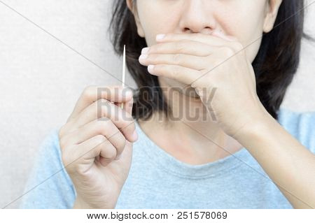 Woman Holding Wooden Toothpick For Cleaning Teeth