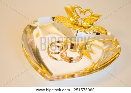 Wedding Symbols Two Rings On Golden Heart-shaped Tray - Love, Family, Celebration, Ceremony Concept