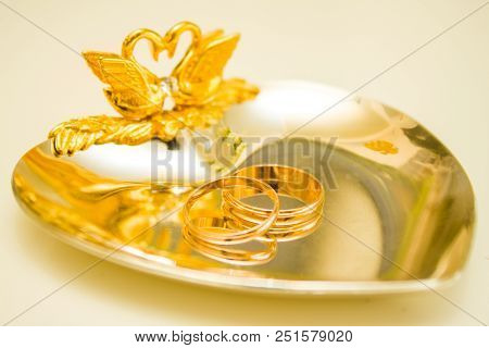 Wedding Symbols Two Rings On Golden Heart-shaped Tray - Love, Family, Celebration, Ceremony Concept