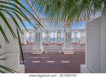 Mediterranean Sea And White Colonnade On Promenade Des Anglais At Sunset In Nice France