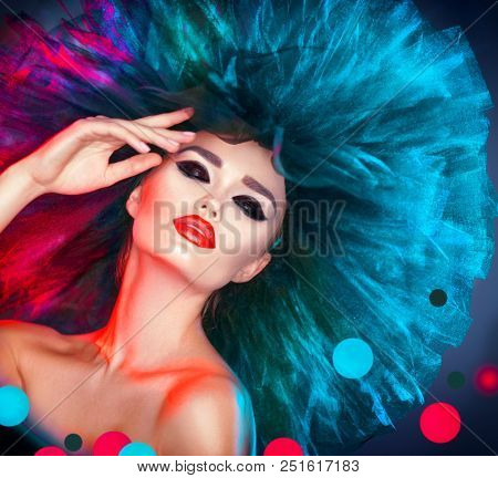 High Fashion model woman in colorful bright neon lights posing, portrait of beautiful sexy girl with trendy make-up and colourful hairdo. Art design, colorful make up. Vivid makeup. Night club dancer