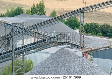 Belt Conveyors And Mining Equipment In A Quarry. Stone Quarry With Conveyor Belts And Piles Of Stone