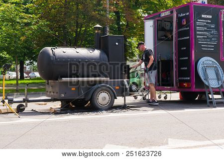Ploiesti, Romania - July 14, 2018: Man Attends Barbecue / Oven In Shape Of Train Locomotive At The M