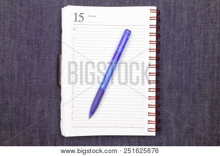Office Notebook With Pen On Jeans Texture