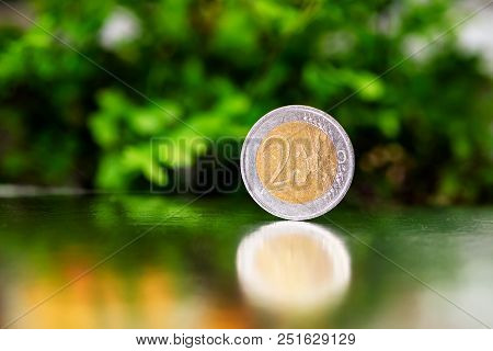 Two Euro Coin Closeup On Silver And Green Background.