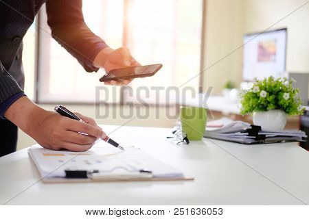 Businessman Checklist On Chart Board Paper Working On Table.