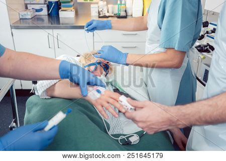 Team of doctors preparing for endoscopy examination while the patient is already sleeping