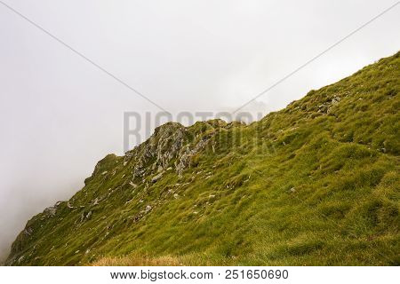 Summer Landscape With High Mountains And Clouds In A Summer Day