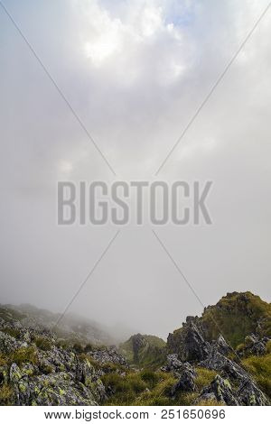 Summer Landscape With High Mountains And Clouds In A Summer Day