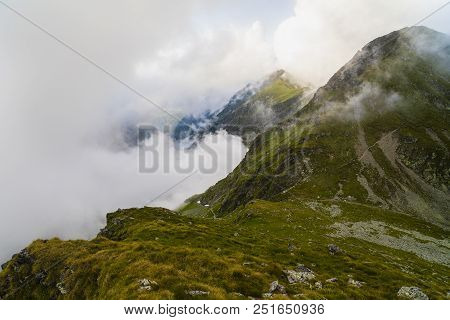 Summer Landscape With High Mountains And Clouds In A Summer Day
