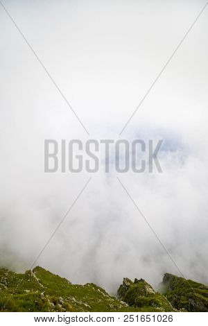 Summer Landscape With High Mountains And Clouds In A Summer Day