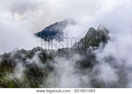 Summer Landscape With High Mountains And Clouds In A Summer Day