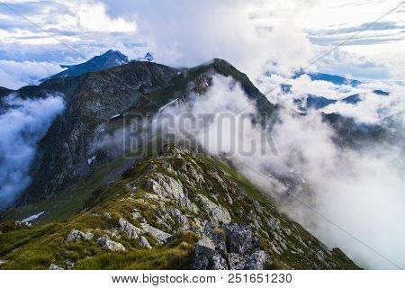 Summer Landscape With High Mountains And Clouds In A Summer Day