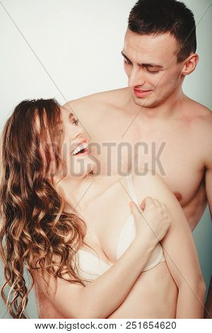 Happy Smiling Sexy Passionate Young Couple Lovers Embracing In Studio. Handsome Muscled Half Naked S
