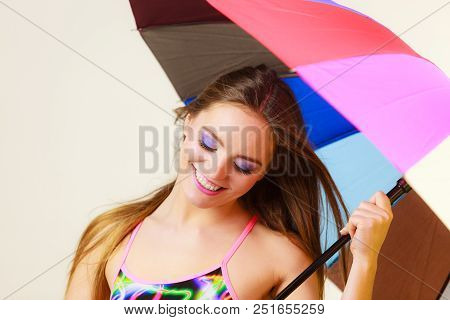 Woman Standing Under Colorful Rainbow Umbrella