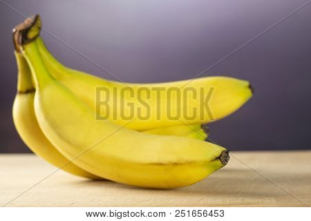 Group Of Five Whole Fresh Yellow Banana One Cluster With Grey Gradient Behind