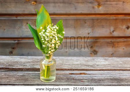 Bouquet Of Flowers Beautiful Smell Lily Of The Valley Or May-lily In Glass Vase On Rustic Old Vintag