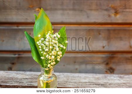 Bouquet Of Flowers Beautiful Smell Lily Of The Valley Or May-lily In Glass Vase On Rustic Old Vintag