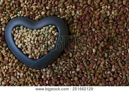 Heart Bowl Filled By Dry Pet Food.