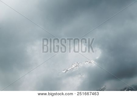 Snow-covered Mountains Of The Himalayas In The Clouds At The Height Of