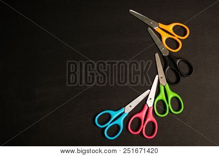 Many Multicolored Scissors Isolated On Black Table