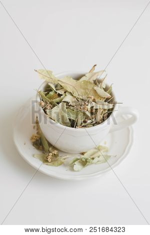 Dried Herbal Tea. Lime Flowers And Leaves In A White Tea Cup. Herbal Drink