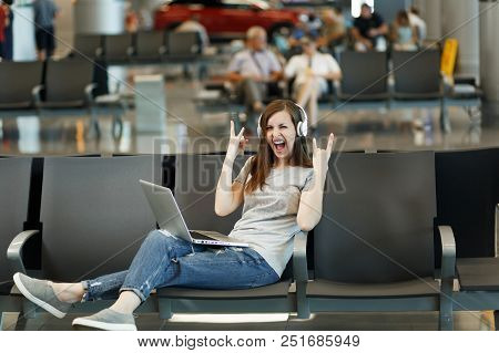 Traveler Tourist Woman With Headphones Listening Music Working On Laptop Showing Rock-nroll Sign Wai