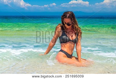 woman sunbathing on the beach summer travel holidays