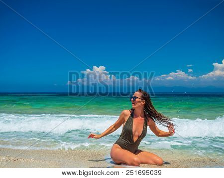 woman sunbathing on the beach summer travel holidays
