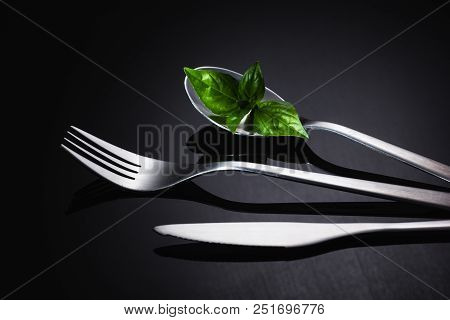 Set Of Stainless Steel Cutlery On A Black Reflective Background, Restaurant Concept