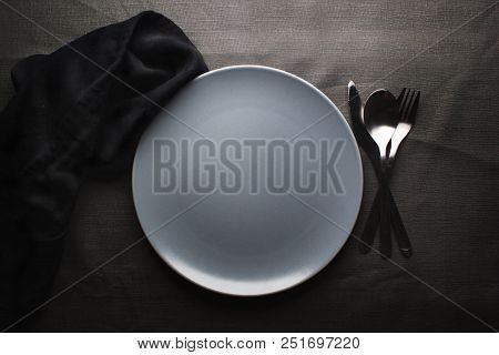 Top View Of A Restaurant Table With Plate, Knife, Fork And A Napkin In Luxurious Restaurant