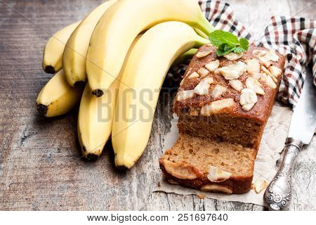 Homemade  Banana Loaf Cake With Fresh Bananas On Wooden Table