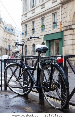 Bycicle Covered With Snow In A Freezing Winter Day In Paris