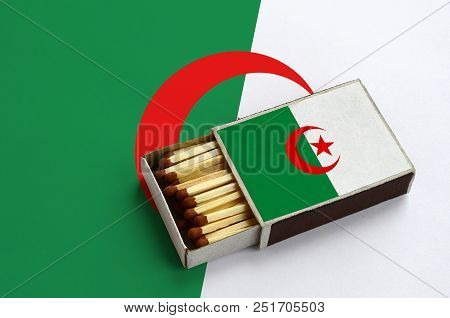 Algeria Flag  Is Shown In An Open Matchbox, Which Is Filled With Matches And Lies On A Large Flag.