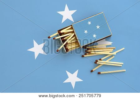 Micronesia Flag  Is Shown On An Open Matchbox, From Which Several Matches Fall And Lies On A Large F