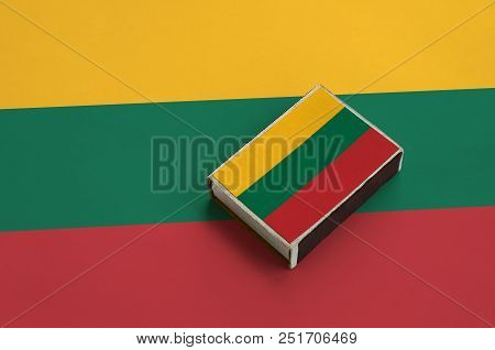 Lithuania Flag  Is Pictured On A Matchbox That Lies On A Large Flag.