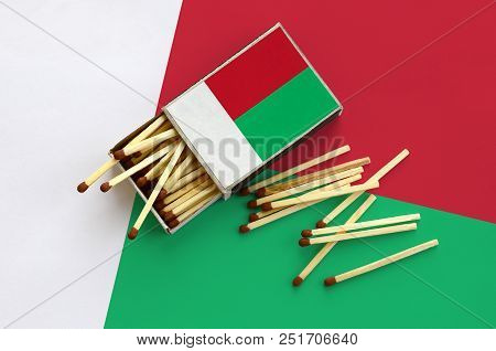 Madagascar Flag  Is Shown On An Open Matchbox, From Which Several Matches Fall And Lies On A Large F