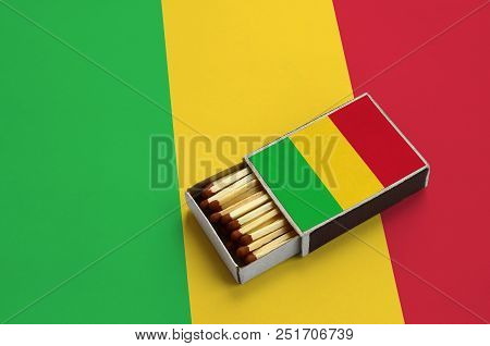 Mali Flag  Is Shown In An Open Matchbox, Which Is Filled With Matches And Lies On A Large Flag.