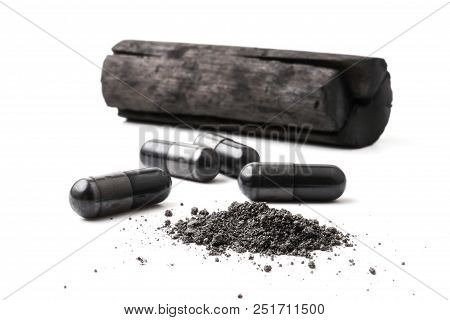 Charcoal (activated Carbon) In Capsules On White Background