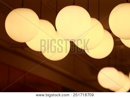 Round Lamp Hanging On The Ceiling In Room.