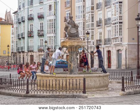 Young Girls And Boys Get Together At The Flora Fountain (fuente De La Flora) On The Historic Huerto 
