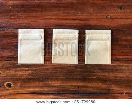 3 Kraft Paper Zipper Lock Bag On The Vintage Wooden Table.empty Packing Bag For Your Product Adverti