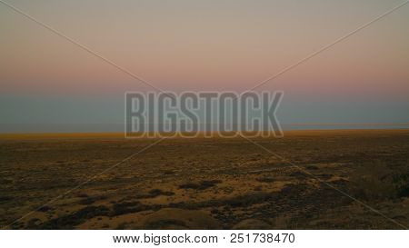 Panorama View To Aral Sea From The Rim Of Plateau Ustyurt Near Aktumsuk Cape At Sunset In Karakalpak