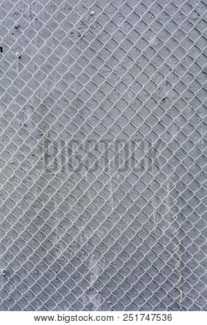 Fence Mesh Urban Background. Wire Iron Fence On Gray Painted Wall