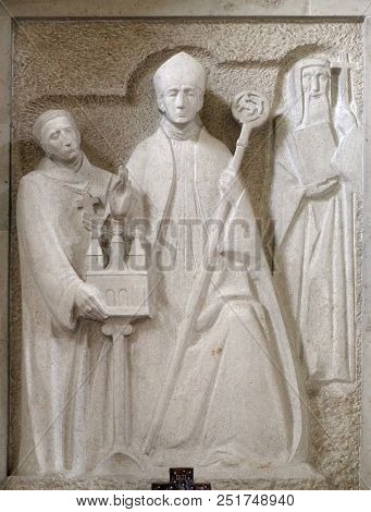 MUNSTERSCHWARZACH, GERMANY - JULY 09: Wurzburg bishop Adalbero, the savior of the monastery Egbert and the holy Makarius of Wurzburg, altar in Munsterschwarzach Abbey, Germany on July 09, 2017.