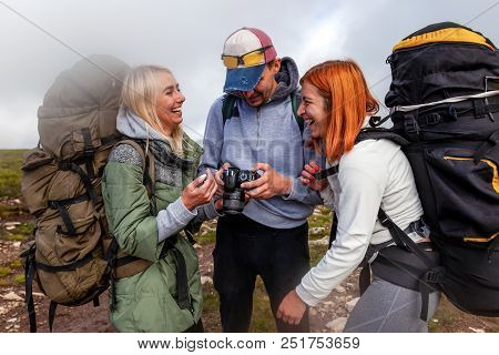 Travel Lifestyle And Survival Concept Rear View. Hiking Man And Women With Backpack Enjoys A Hike  A