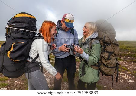 Travel Lifestyle And Survival Concept Rear View. Hiking Man And Women With Backpack Enjoys A Hike  A
